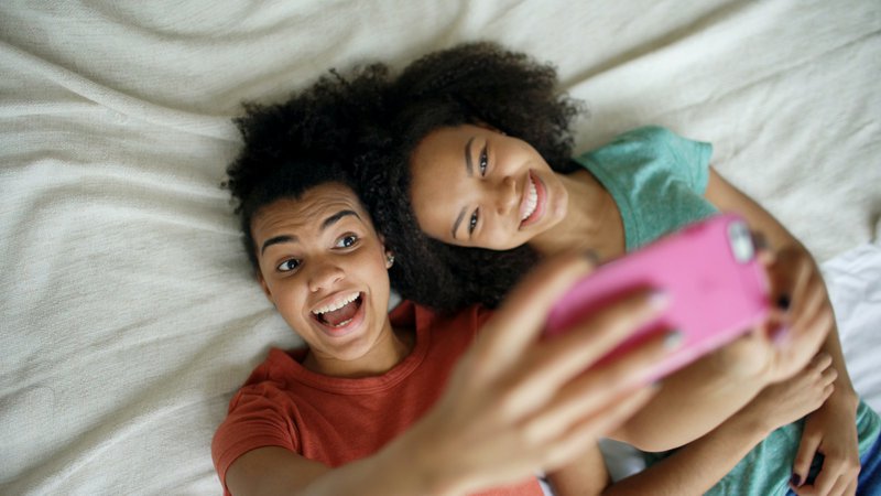Two smiling young women taking a selfie